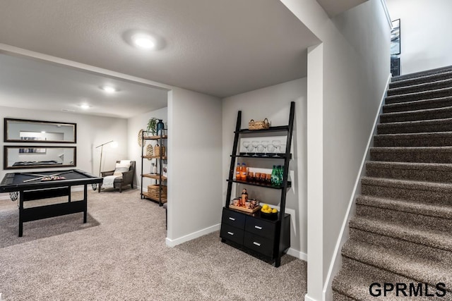 playroom featuring baseboards and light carpet