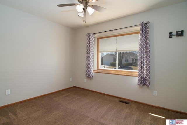 spare room with visible vents, baseboards, carpet floors, and ceiling fan