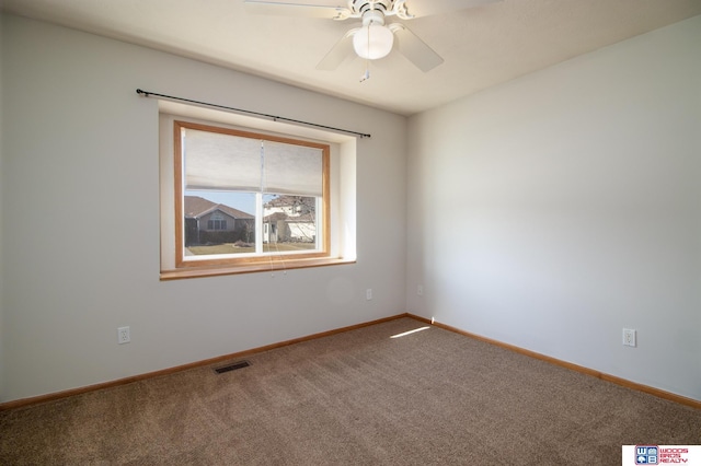 spare room featuring a ceiling fan, baseboards, visible vents, and carpet floors