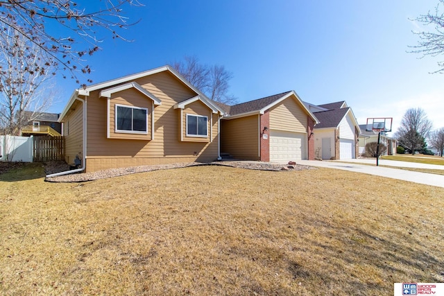 ranch-style home featuring an attached garage, driveway, a front lawn, and fence