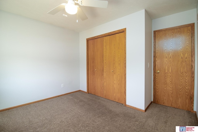 unfurnished bedroom with a closet, baseboards, a ceiling fan, and carpet flooring