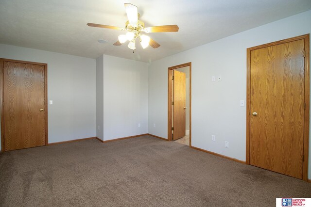 unfurnished bedroom featuring baseboards, carpet floors, and a ceiling fan