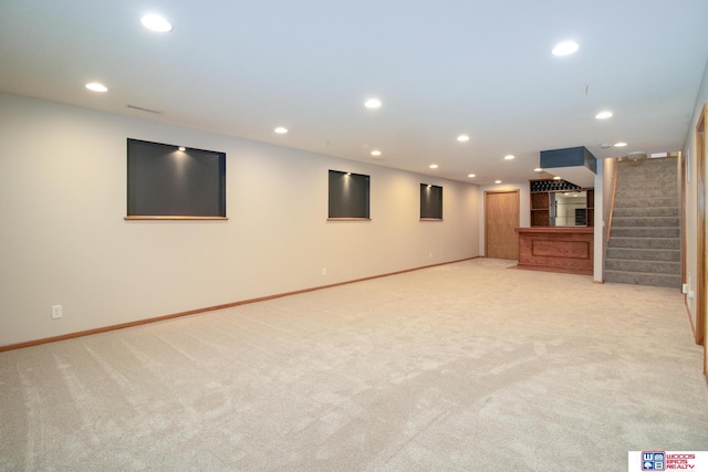 interior space with stairs, recessed lighting, light colored carpet, and baseboards