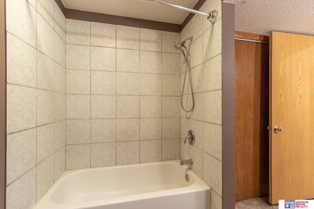 full bath with a textured ceiling and  shower combination