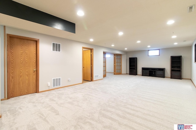 unfurnished living room featuring recessed lighting and visible vents