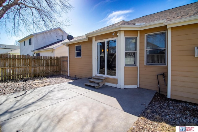 exterior space featuring entry steps and fence