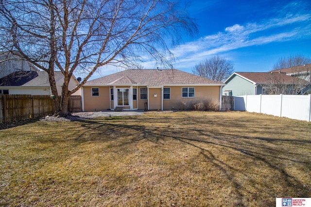 back of property featuring a yard, a fenced backyard, and a patio area