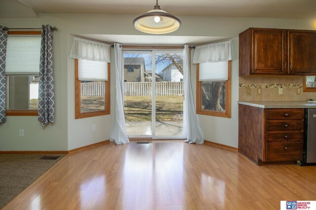 unfurnished dining area featuring visible vents, baseboards, and light wood-style floors