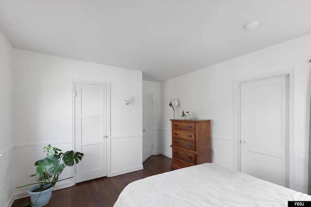 bedroom with dark wood finished floors