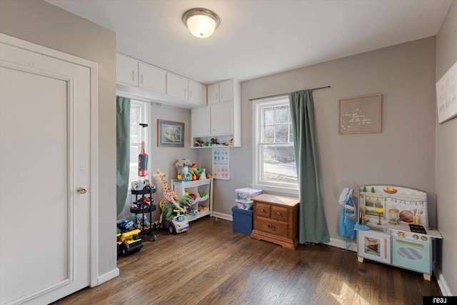 game room with baseboards and hardwood / wood-style flooring