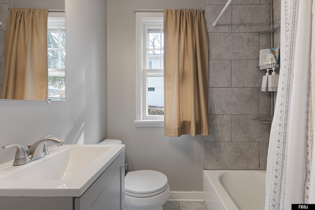 full bath featuring vanity, baseboards, bathtub / shower combination, tile patterned flooring, and toilet