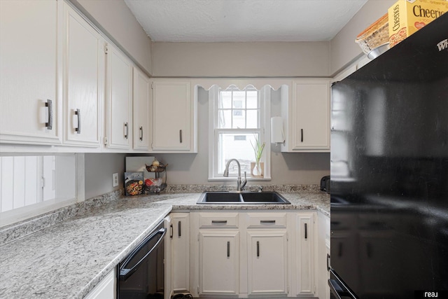 kitchen with a textured ceiling, white cabinets, black dishwasher, and a sink