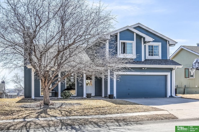 view of front of home with driveway, a shingled roof, and a garage