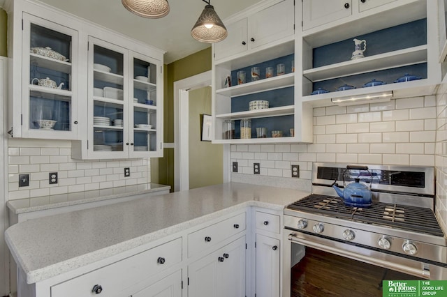 kitchen featuring open shelves, decorative light fixtures, white cabinetry, stainless steel range with gas cooktop, and glass insert cabinets