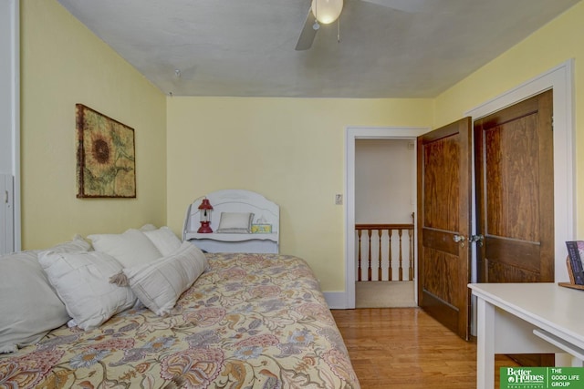 bedroom with a ceiling fan, baseboards, and light wood finished floors