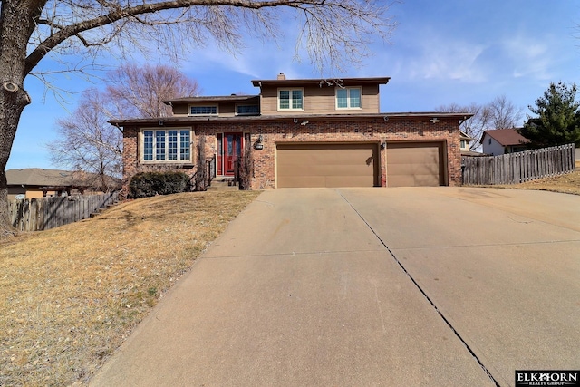 view of front facade with fence, brick siding, driveway, and a chimney