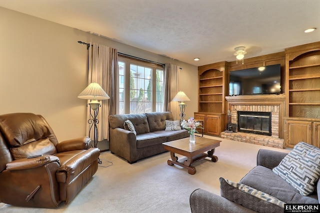 carpeted living room with built in features, a fireplace, and a textured ceiling