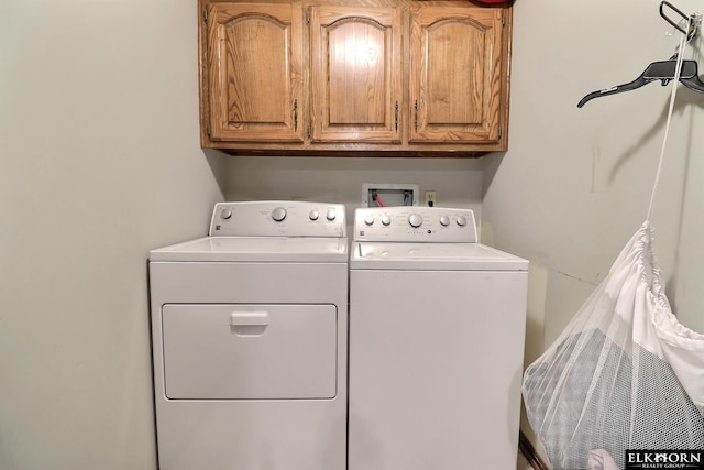 washroom featuring cabinet space and washing machine and dryer