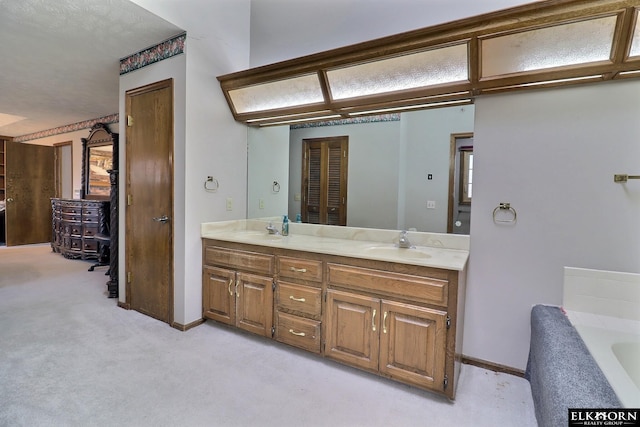 bathroom with a closet, double vanity, a bathtub, and a sink