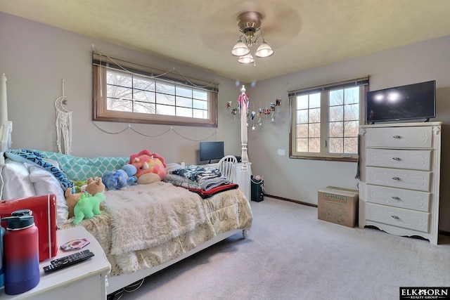 bedroom with multiple windows, baseboards, and carpet floors