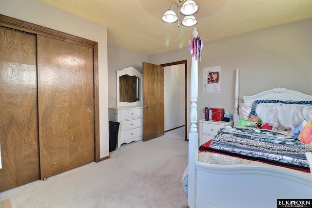 bedroom with a closet and light colored carpet