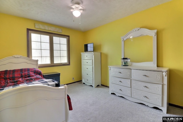 bedroom featuring light carpet and baseboards