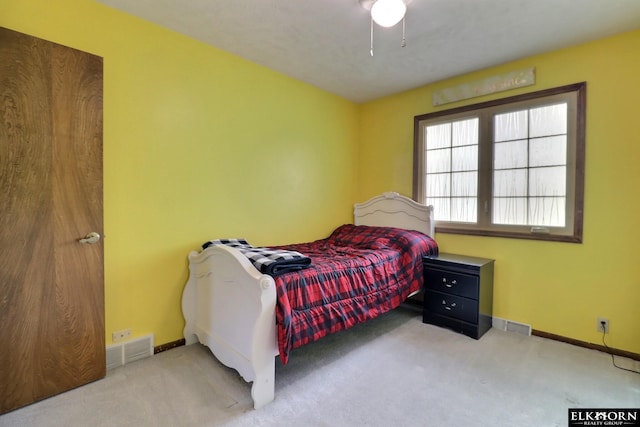 carpeted bedroom featuring baseboards and visible vents