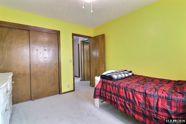 bedroom with a closet and light colored carpet