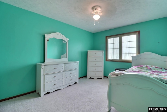 bedroom with baseboards, light colored carpet, ceiling fan, and a textured ceiling