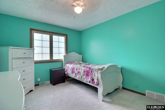 bedroom with visible vents, baseboards, and carpet