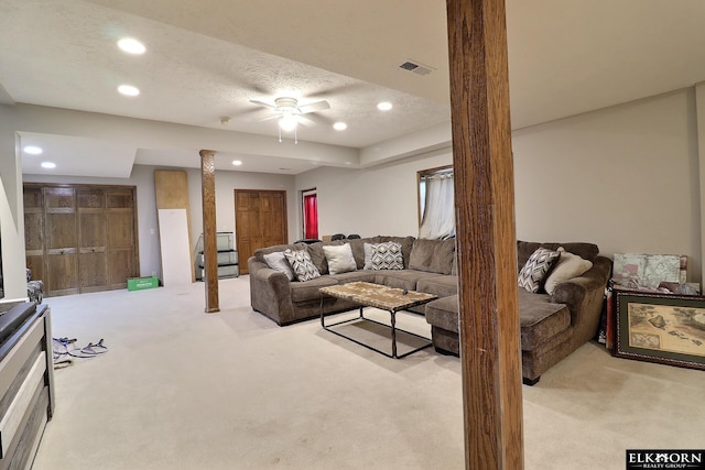 carpeted living room featuring recessed lighting, visible vents, a textured ceiling, and a ceiling fan