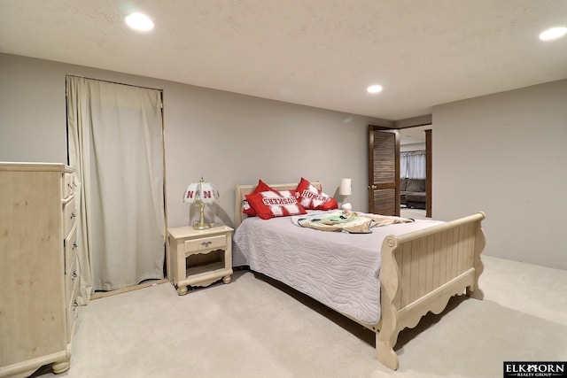 bedroom with recessed lighting and light colored carpet