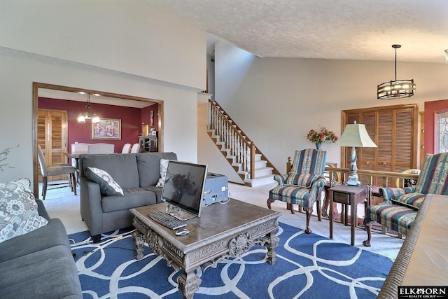 living area featuring an inviting chandelier, stairway, and carpet