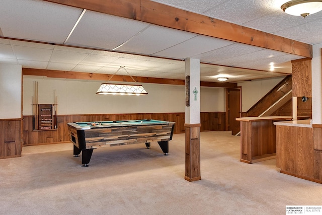 recreation room with wooden walls, light colored carpet, visible vents, and wainscoting