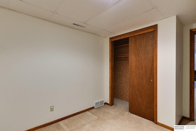 unfurnished bedroom with light carpet, visible vents, and baseboards