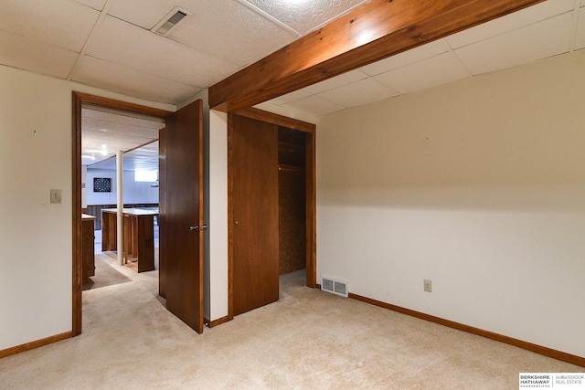 spare room featuring carpet flooring, baseboards, and visible vents