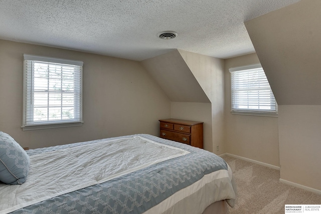 bedroom featuring multiple windows, baseboards, visible vents, and carpet floors