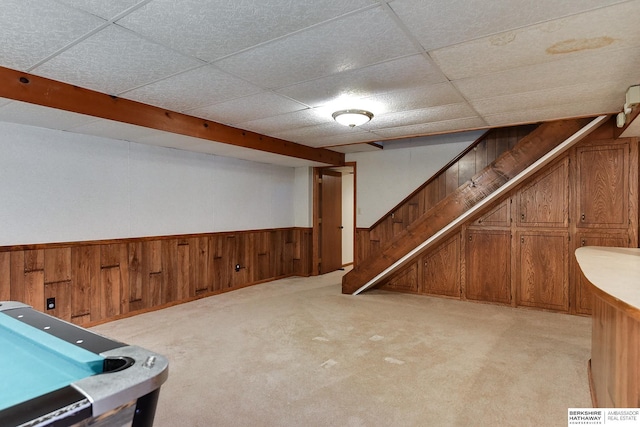 rec room featuring a wainscoted wall, light carpet, visible vents, a drop ceiling, and wood walls