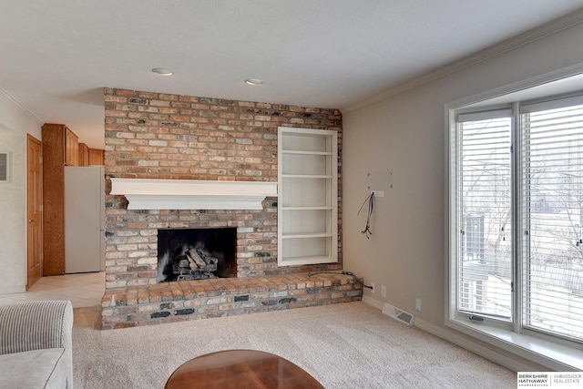 unfurnished living room with visible vents, a healthy amount of sunlight, and light colored carpet