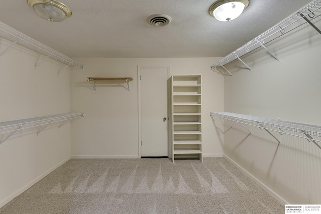 spacious closet with visible vents and carpet flooring