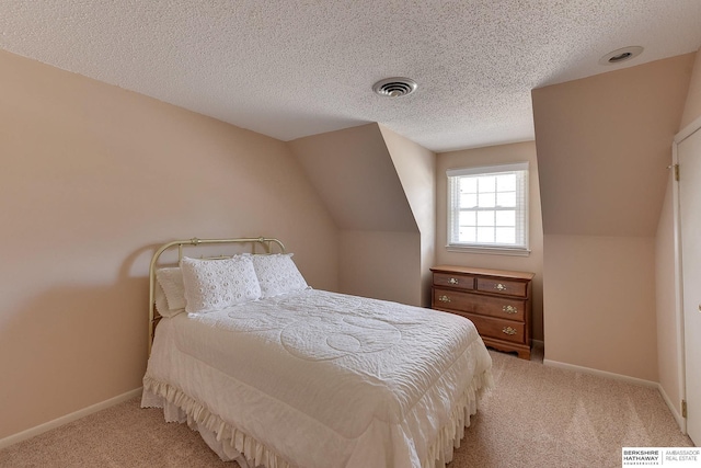 carpeted bedroom featuring visible vents, baseboards, a textured ceiling, and vaulted ceiling