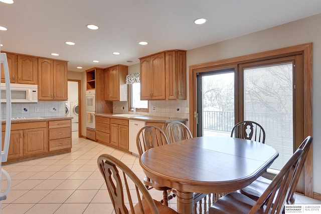 dining space featuring light tile patterned floors, recessed lighting, and washing machine and clothes dryer