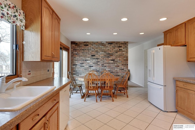 kitchen with white appliances, light tile patterned floors, recessed lighting, a sink, and decorative backsplash