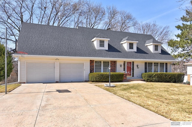 cape cod-style house featuring a front yard, concrete driveway, brick siding, and roof with shingles