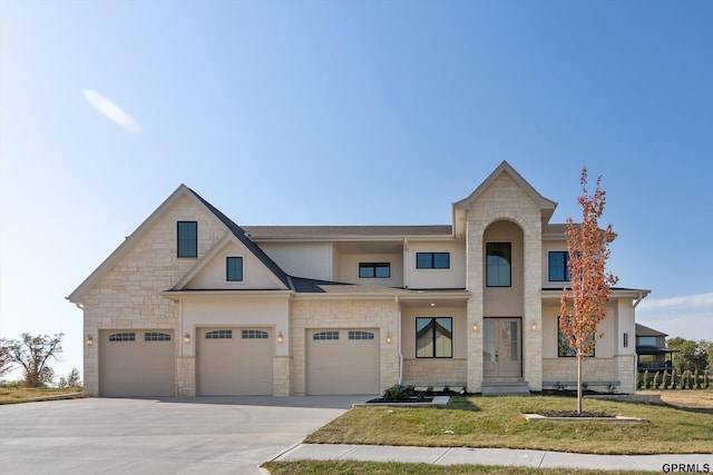 view of front of house featuring stone siding, concrete driveway, a garage, and a front yard