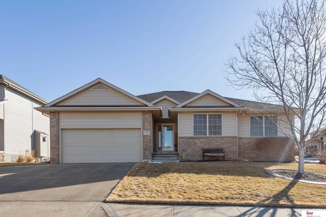 ranch-style house featuring a front yard, brick siding, a garage, and driveway