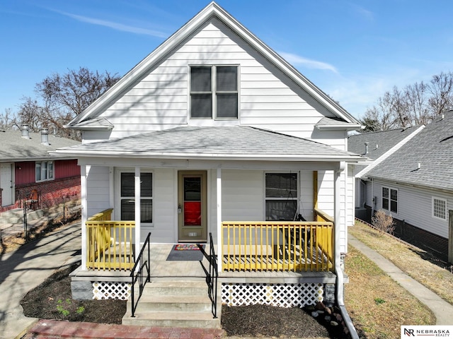 view of front of home with a porch and a shingled roof