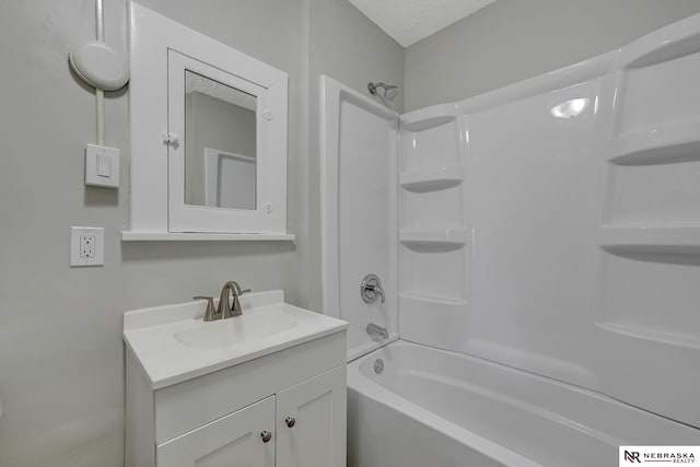 bathroom featuring shower / washtub combination and vanity