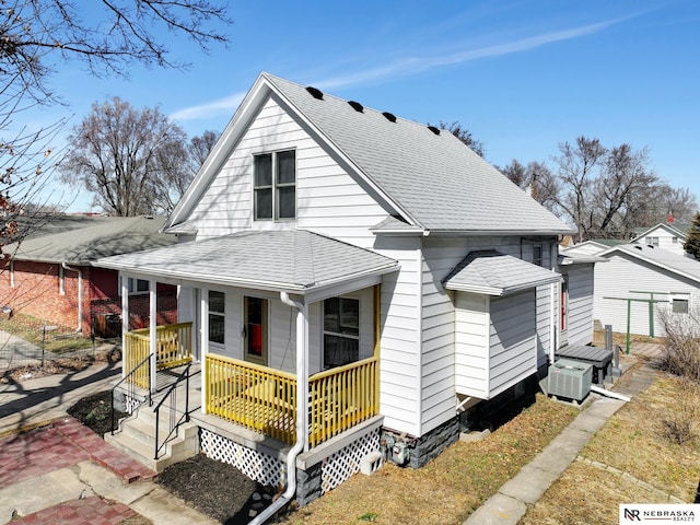 view of front of property with covered porch and roof with shingles