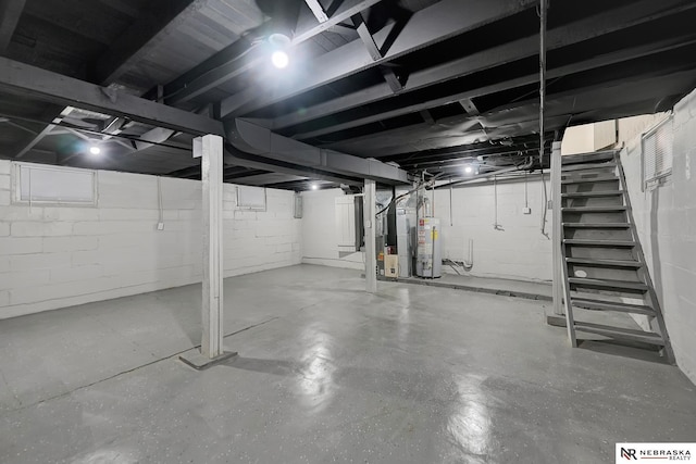 unfinished basement with heating unit, stairway, and gas water heater